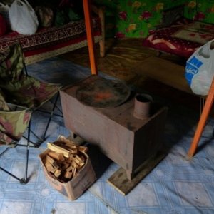 This time we had to put the stove pipe up and get a fire  going.  Wide linoleum rolled out on the ground which had swept clean of pebbles was a common