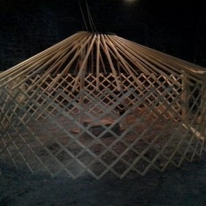 Wood roof poles, metal pins, and a metal roof ring. It had a tendency to spiral down and in on itself.  The roof is precariously balanced on three pol