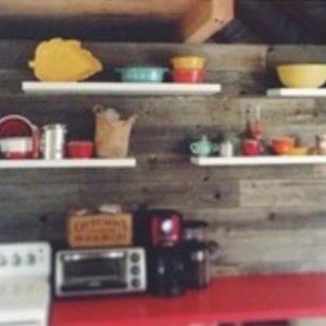 Barnboard wall separating bedroom/kitchen