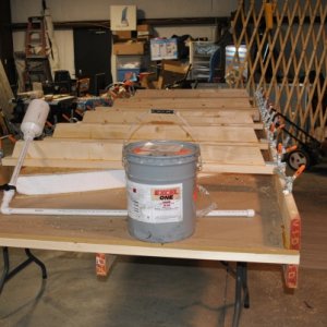 The Yurt has a 4 inch foam insulated subfloor.  This picture shows the press I made to clamp the OSB to the foam for gluing

 .  The glue is Gorilla G