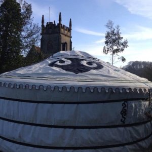 A view of the yurt from behind with the village church