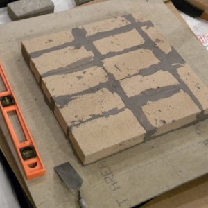 Heater core first course (cement board on top of lightweight concrete on top of 12 ga sheet of steel on top of cinder blocks on top of leveling sand).