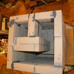 Upper half of upper bell. The firebrick spanning the U-shape blocks heat from a direct path to the chimney, which will exit through the little 6.5x6.5