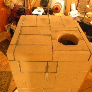 The top, with the chimney/stovepipe hole which still needs some work (right-most bricks not mortared in).