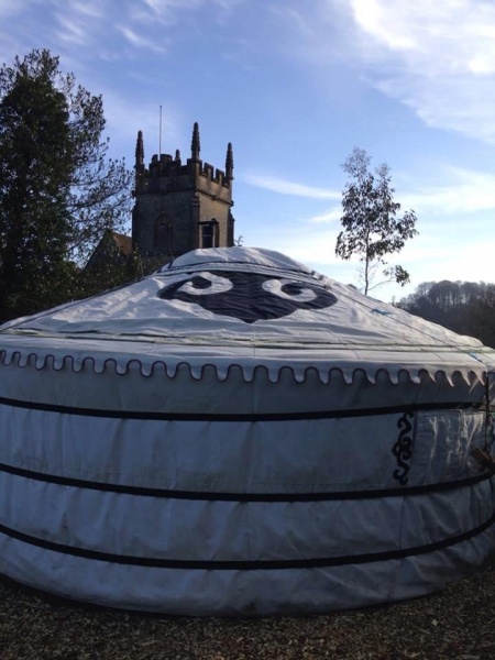 A view of the yurt from behind with the village church