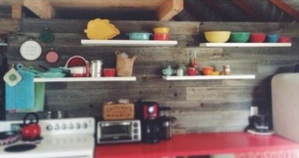 Barnboard wall separating bedroom/kitchen