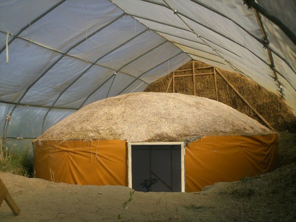 fhalf finished mycelium-earth-yurt in the greenhouse