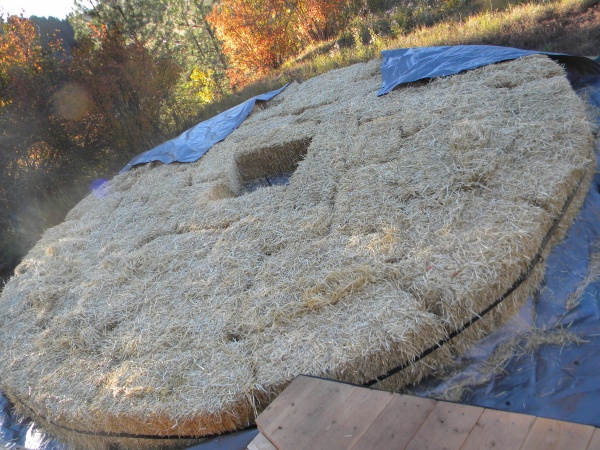 Gaps in full bales filled in. Hole in center for sturdier/unburnable foundation under wood heater.