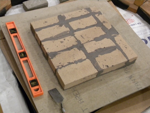 Heater core first course (cement board on top of lightweight concrete on top of 12 ga sheet of steel on top of cinder blocks on top of leveling sand).