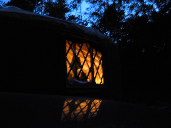 Pic of the yurt from outside at night.  The reflection is the top of my truck.