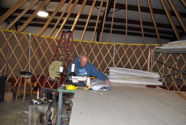 Sewing wall insulation panels.