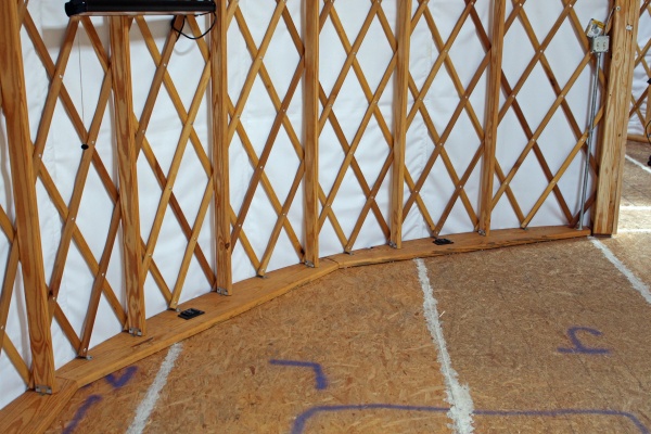 The picture highlights the base blocking under the Yurt frame. Base blocking provides a number of advantages - including raising the overall Yurt heig