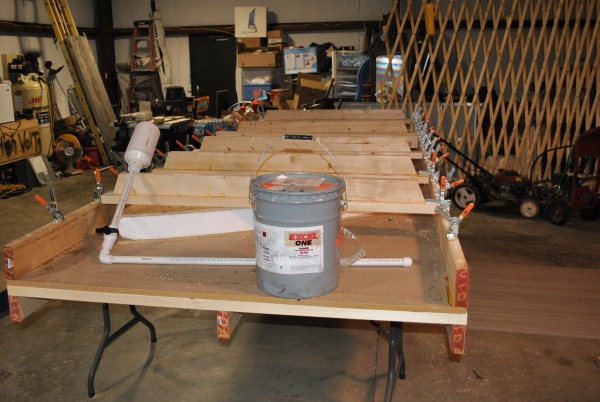 The Yurt has a 4 inch foam insulated subfloor.  This picture shows the press I made to clamp the OSB to the foam for gluing

 .  The glue is Gorilla G
