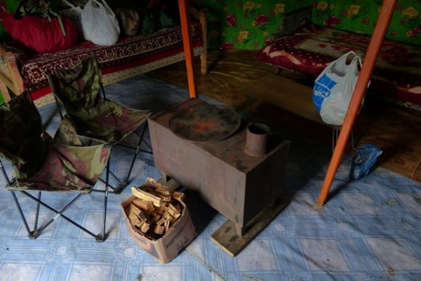This time we had to put the stove pipe up and get a fire  going.  Wide linoleum rolled out on the ground which had swept clean of pebbles was a common