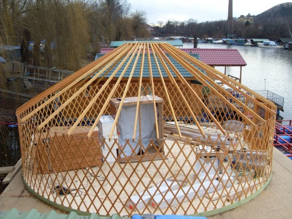 Yurt framework being installed onto the platform.