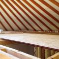 Loft floor going down. The floor, like the interior walls, does not meet the yurt walls.  A 4 inch gap has been left to allow air to move freely