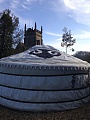 A view of the yurt from behind with the village church