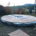 Yurt platform, silver edition. Leveled ground, tamped gravel, tarp, strawbales, tarp folded on top of bales & taped with tyvek to seal, platform...