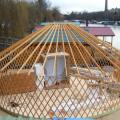 Yurt framework being installed onto the platform.